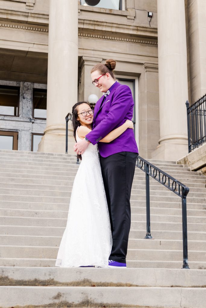 Couple photography stairs. Boise, Idaho state Capitol building couples photography. Boise wedding photography. Purple color scheme. Couples photography poses.